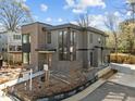 Contemporary home featuring brick and gray siding with large windows and modern design elements at 2305 Turners Aly, Raleigh, NC 27607