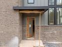 Close-up of a stylish front door, showcasing the brick exterior and modern design at 2305 Turners Aly, Raleigh, NC 27607