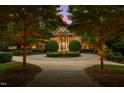 Stately brick home featuring a circular driveway and fountain at 2421 Acanthus Dr, Wake Forest, NC 27587