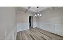 Elegant dining room showcases a stylish chandelier and wainscoting at 257 Swann Trl, Clayton, NC 27527