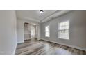 Inviting living room featuring arched entryways, wood floors, and natural light at 257 Swann Trl, Clayton, NC 27527