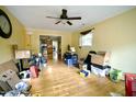 A spacious living room with hardwood floors, a ceiling fan, and natural light at 2726 Thelma St, Durham, NC 27704