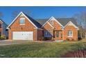 Charming brick home with manicured lawn, attached garage and detailed architectural trim at 3109 Doe Hill Ct, Raleigh, NC 27612