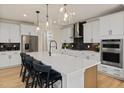 Spacious kitchen with a large island, stainless steel appliances, and modern pendant lighting at 353 Belmont Stakes Ln, Wendell, NC 27591