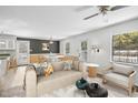 Comfortable living room with stylish sofa, ceiling fan and open floor plan to dining area at 3746 Guess Rd, Durham, NC 27705
