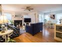 Bright living room featuring a cozy fireplace, hardwood floors, and comfortable seating arrangement at 4212 Birmingham Way, Raleigh, NC 27604
