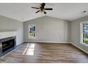 Bright living room with vaulted ceilings, laminate floors, and a cozy fireplace at 4804 Red Coat Ct, Raleigh, NC 27616