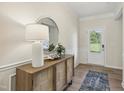 Bright entryway with wood floors, stylish console table, and decorative mirror at 4879 Pioneer Dr, Sanford, NC 27330