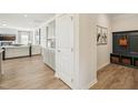 Hallway with modern cabinets, a coat rack, and access to the living area at 4879 Pioneer Dr, Sanford, NC 27330