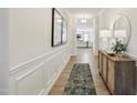 Hallway featuring wood floors, decorative trim, and stylish decor at 4879 Pioneer Dr, Sanford, NC 27330