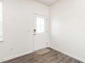 Bright entryway featuring a white door with decorative glass and durable laminate flooring at 516 Spaulding St, Burlington, NC 27215