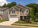 Charming two-story home with a two-car garage and manicured lawn, perfect for curb appeal at 516 Spaulding St, Burlington, NC 27215