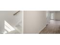 Carpeted stairway with a light-filled hallway, leading to a door with backyard access and modern flooring at 521 Fife Ct, Gibsonville, NC 27249