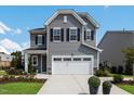 Charming two-story home with a well-maintained lawn, attached two car garage, and tasteful landscaping at 637 Emerald Bay Cir, Raleigh, NC 27610