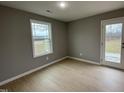 Bright bedroom with a large window and access to the backyard at 76 Mangrove Ct, Four Oaks, NC 27524