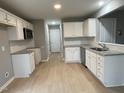 Modern kitchen featuring stainless steel appliances, granite countertops and white cabinets at 76 Mangrove Ct, Four Oaks, NC 27524