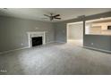 Spacious living room featuring a fireplace and views of the kitchen at 76 Mangrove Ct, Four Oaks, NC 27524