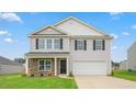 Charming two-story home featuring a two-car garage, stone accents, and a well-manicured lawn at 857 Forth Ct, Gibsonville, NC 27249