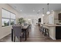 Open-concept dining area with hardwood floors and views of the kitchen and living room at 917 Matterhorn Dr, Fuquay Varina, NC 27526