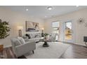 Bright living room with neutral colors, stylish furniture, hardwood floors, and a view of the backyard at 917 Matterhorn Dr, Fuquay Varina, NC 27526
