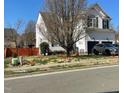 Charming two-story home featuring an attached garage, well-kept lawn, and budding trees at 917 Widewaters Pkwy, Knightdale, NC 27545