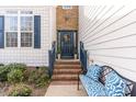 Charming front door with brick steps, decorated with a wreath and a decorative bench at 917 Widewaters Pkwy, Knightdale, NC 27545