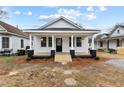 Inviting single-story home with a classic front porch and well-maintained exterior at 1034 Maple St, Henderson, NC 27536