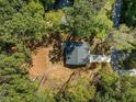 Aerial view of a compact home surrounded by dense trees providing lots of shade and privacy at 107 Cochise Dr, Louisburg, NC 27549