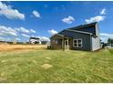 Expansive backyard with fresh sod installed and a covered back porch at 130 W Crescent Mills Blvd # Homesite 251, Wilson's Mills, NC 27520