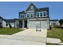 Beautiful two-story home featuring a modern color scheme, stone accents and a wide driveway at 130 W Crescent Mills Blvd # Homesite 251, Wilson's Mills, NC 27520