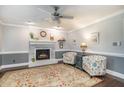 Cozy living room with a painted brick fireplace, a ceiling fan, and comfortable seating at 1316 Raybon Dr, Wendell, NC 27591