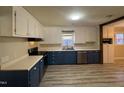 Spacious kitchen featuring stainless steel appliances, white countertops, and blue cabinets at 1618 Gerringer Mill Rd, Burlington, NC 27217