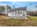 Expansive backyard featuring a spacious deck, concrete patio, and lush green space at 173 Allie Dr, Garner, NC 27529