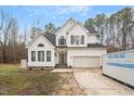 Beautiful two-story home featuring a manicured lawn, attached garage, and classic architectural details at 173 Allie Dr, Garner, NC 27529