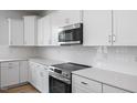 This modern kitchen features white cabinets, stainless steel appliances and white subway tile backsplash at 173 Wild Turkey Way, Lillington, NC 27546