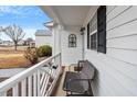 Cozy front porch featuring a bench and decorative details, perfect for relaxing outdoors at 201 Moss Creek Dr, Clayton, NC 27520