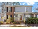 Charming two-story home featuring a mix of siding and brick with a well-manicured front yard and porch at 205 Clancy Cir, Cary, NC 27511