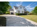View of the home's exterior featuring an attached garage and extended driveway at 222 Friesan Way, Rolesville, NC 27571