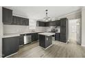 Stylish kitchen features dark cabinetry, stainless appliances, and a center island at 248 Dutches Ln, Henderson, NC 27537