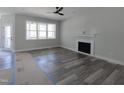 Living room featuring a fireplace, hardwood floors, a ceiling fan, and lots of natural light at 307 7Th St, Butner, NC 27509