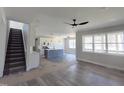 Open-concept living room featuring hardwood floors, a staircase, and lots of natural light at 307 7Th St, Butner, NC 27509