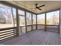 Screened-in porch with a ceiling fan overlooking the backyard and mature trees at 307 7Th St, Butner, NC 27509