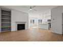 Open living space with fireplace, built in shelves, and access to the kitchen area at 336 Pecan Valley Way, Four Oaks, NC 27524