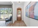 Hallway entrance to an office with a hardwood floor, art and front door at 3727 Bellevue Rd, Raleigh, NC 27609