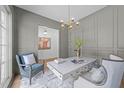 Stylish home office featuring gray walls, a modern desk, and a chic chandelier at 3727 Bellevue Rd, Raleigh, NC 27609