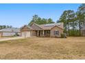 Inviting single-story home with solar panels, a two-car garage, and a well-kept lawn at 38 Parkside Dr, Lillington, NC 27546