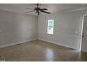 Bright, spacious living room featuring tiled floors, a ceiling fan, and natural light at 412 Nc-82, Dunn, NC 28334