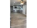 Open-concept layout showcases a modern kitchen with gray cabinets, stainless steel appliances, and luxury vinyl plank flooring at 471 Merriman St, Henderson, NC 27536