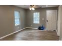 Bright living room featuring luxury vinyl plank flooring, neutral paint, and ample natural light at 471 Merriman St, Henderson, NC 27536