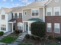 A townhome featuring a charming exterior with brick and vinyl siding and a well-manicured lawn at 5333 Crescentview Pkwy, Raleigh, NC 27606